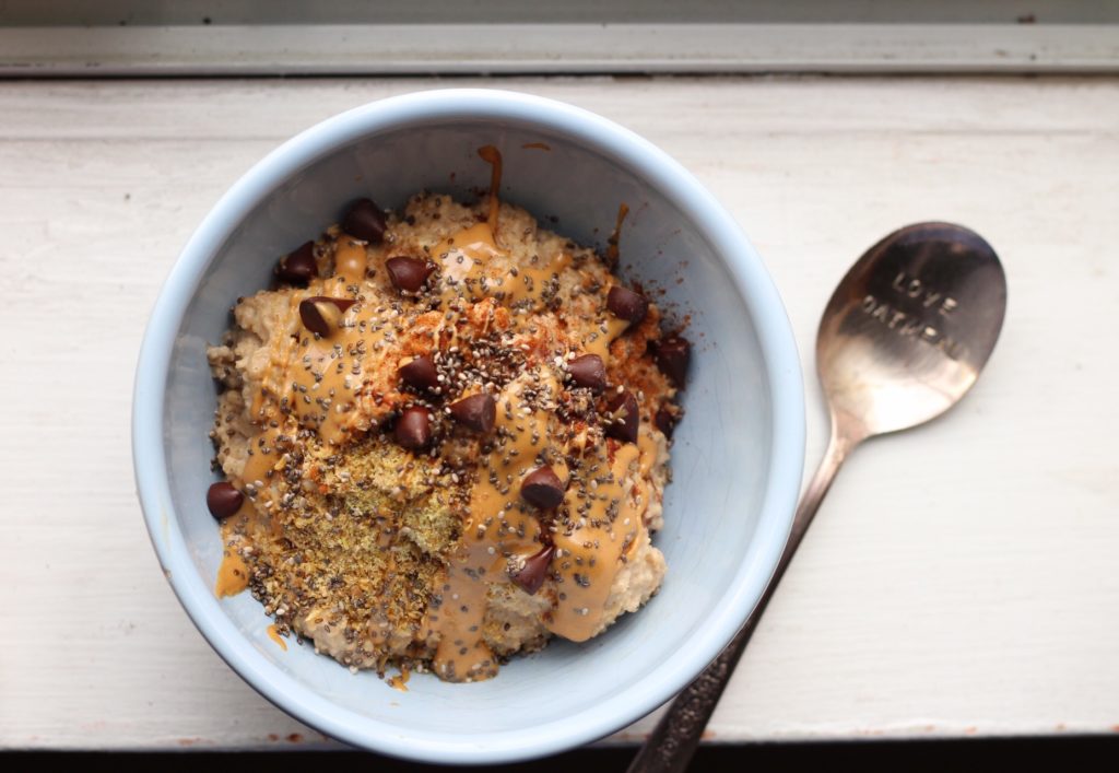 Chocolate Chip Cookie Oat Bran Porridge: Oatmeal gets a throwback to oat BRAN. This is breakfast is super creamy, healthful and filling, and even vegan! You'll feel like you're eating a cookie for breakfast, too. #vegan #oatmeal #eatrealfood #breakfast 