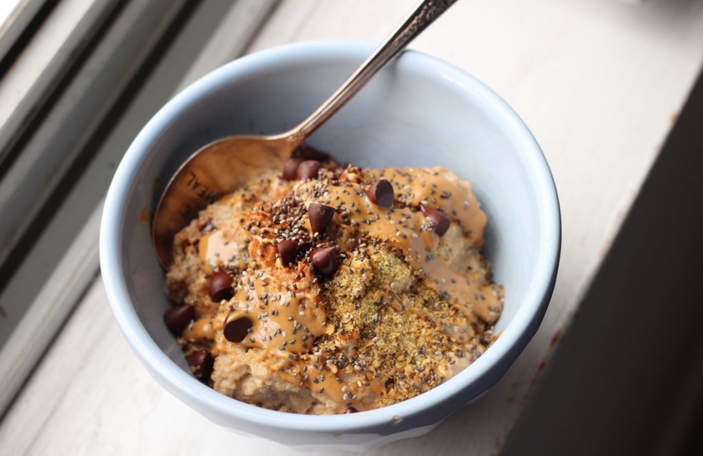 Chocolate Chip Cookie Oat Bran Porridge: Oatmeal gets a throwback to oat BRAN. This is breakfast is super creamy, healthful and filling, and even vegan! You'll feel like you're eating a cookie for breakfast, too. #vegan #oatmeal #eatrealfood #breakfast 