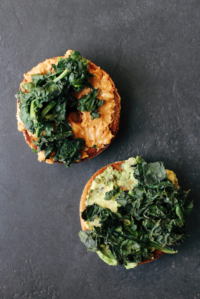 Crispy Kale Bagel Sandwiches. An easy, #vegan and #vegetarian breakfast idea: layer crispy kale on top of salted avocado and peanut butter.