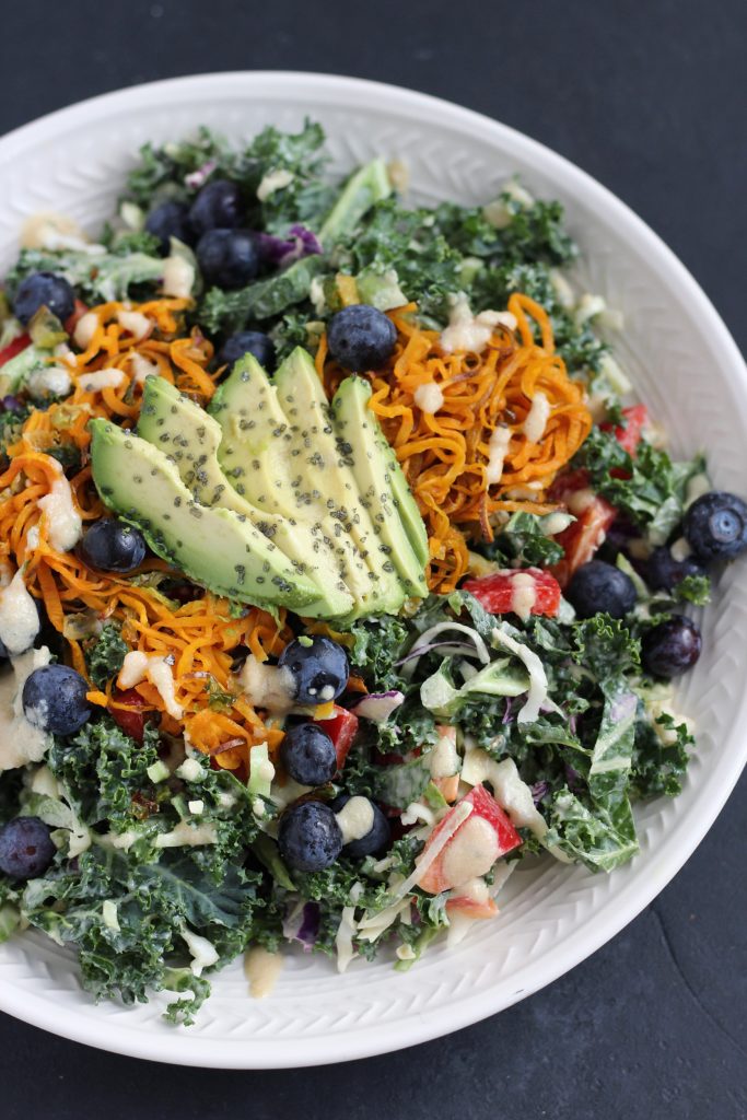 A simple kale and raw veggie salad with a creamy maple tahini dressing. Vegan, gluten free and flexible for ingredients you have on hand!